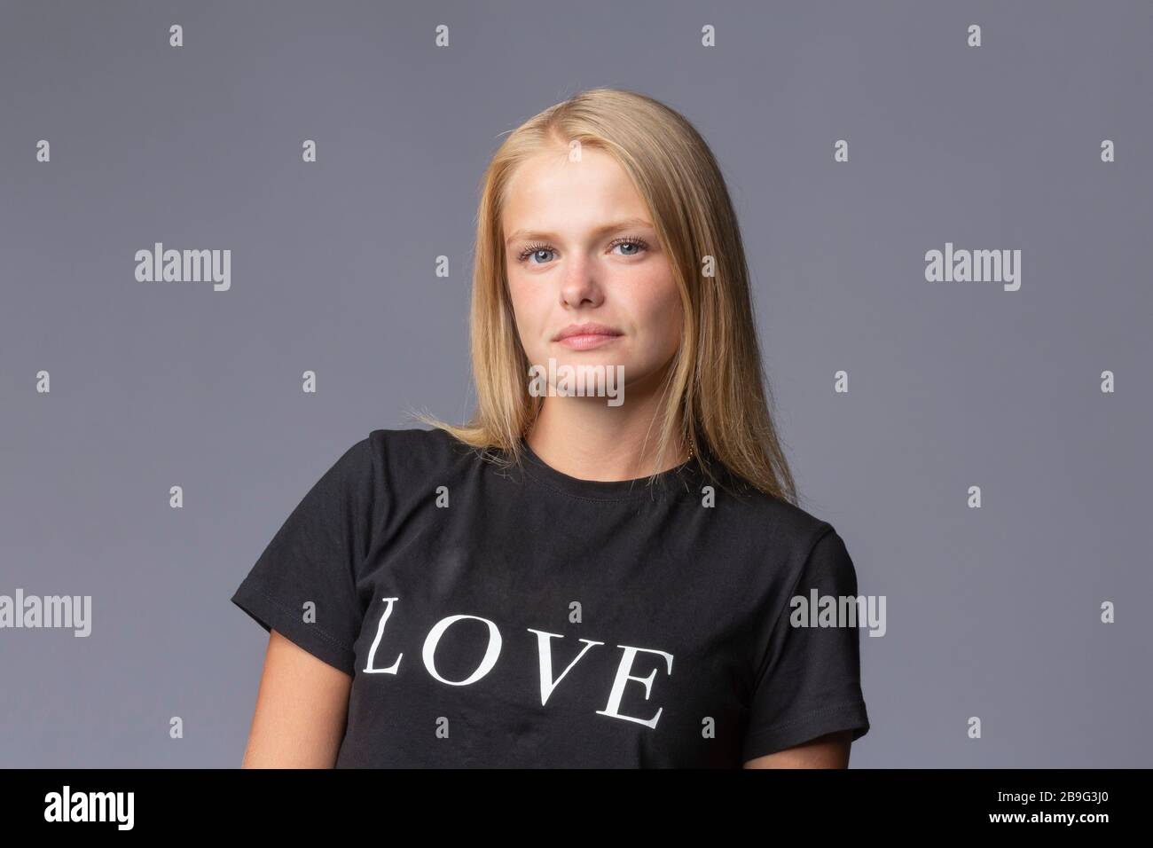 Portrait une jeune femme blonde confiante dans un t-shirt d'amour Banque D'Images
