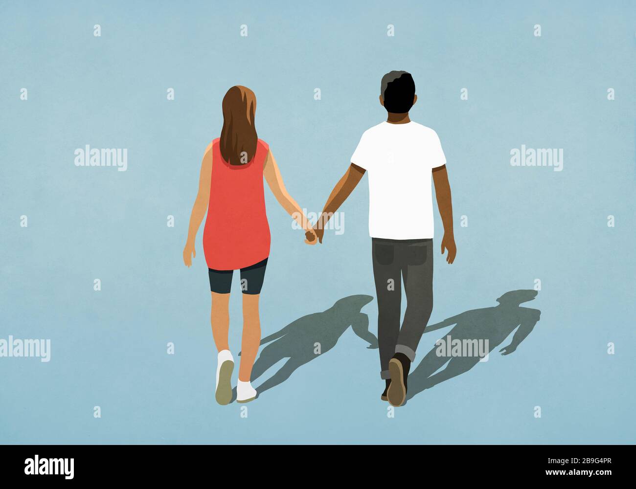 Couple multiethnique tenant les mains et marchant Banque D'Images