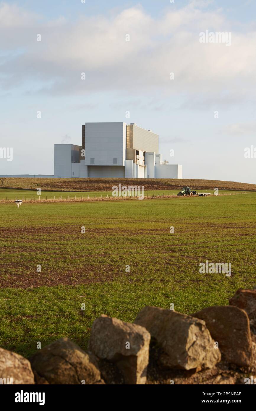 Centrale nucléaire Torness avec tracteur et mur en pierre sèche en premier plan Banque D'Images