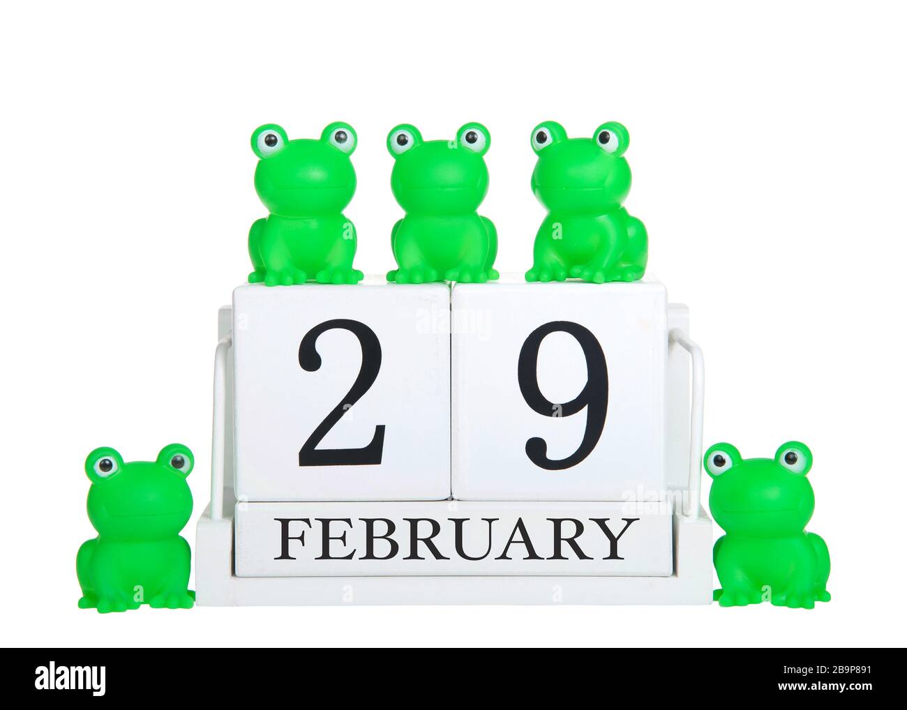 Blocs de calendrier blanc 29 février isolés sur fond blanc avec des grenouilles vertes génériques sur et autour du calendrier. Thème année bissextile Banque D'Images
