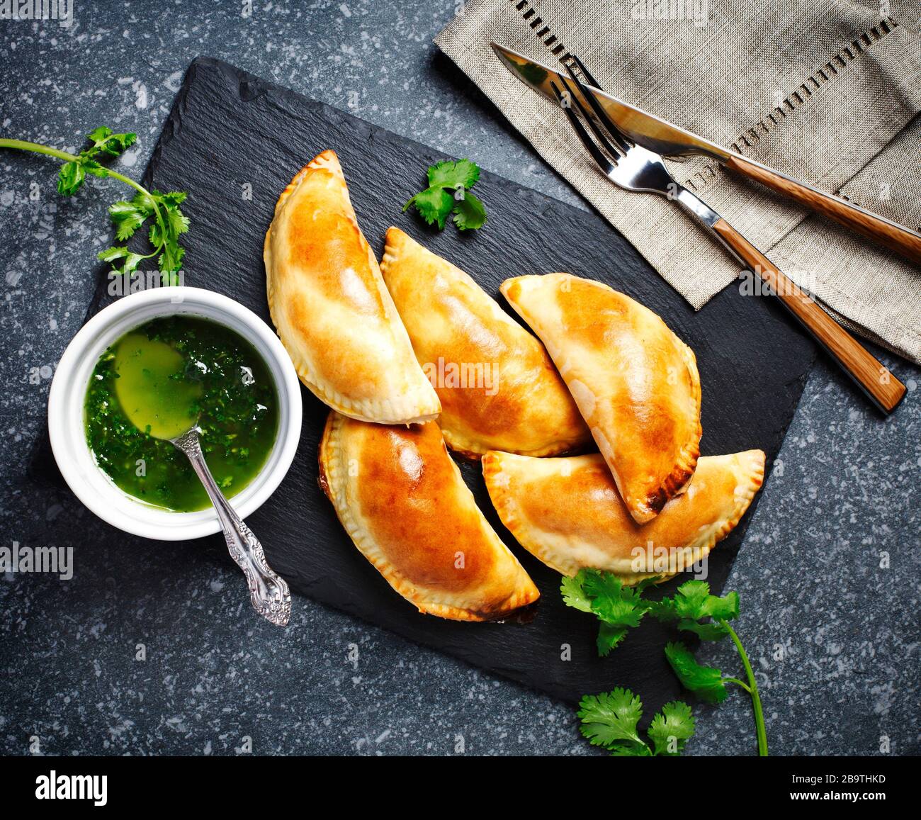 Empanadas avec sauce chimichuri. Cuisine de tradition latino-américaine. Vue de dessus, espace de copie Banque D'Images