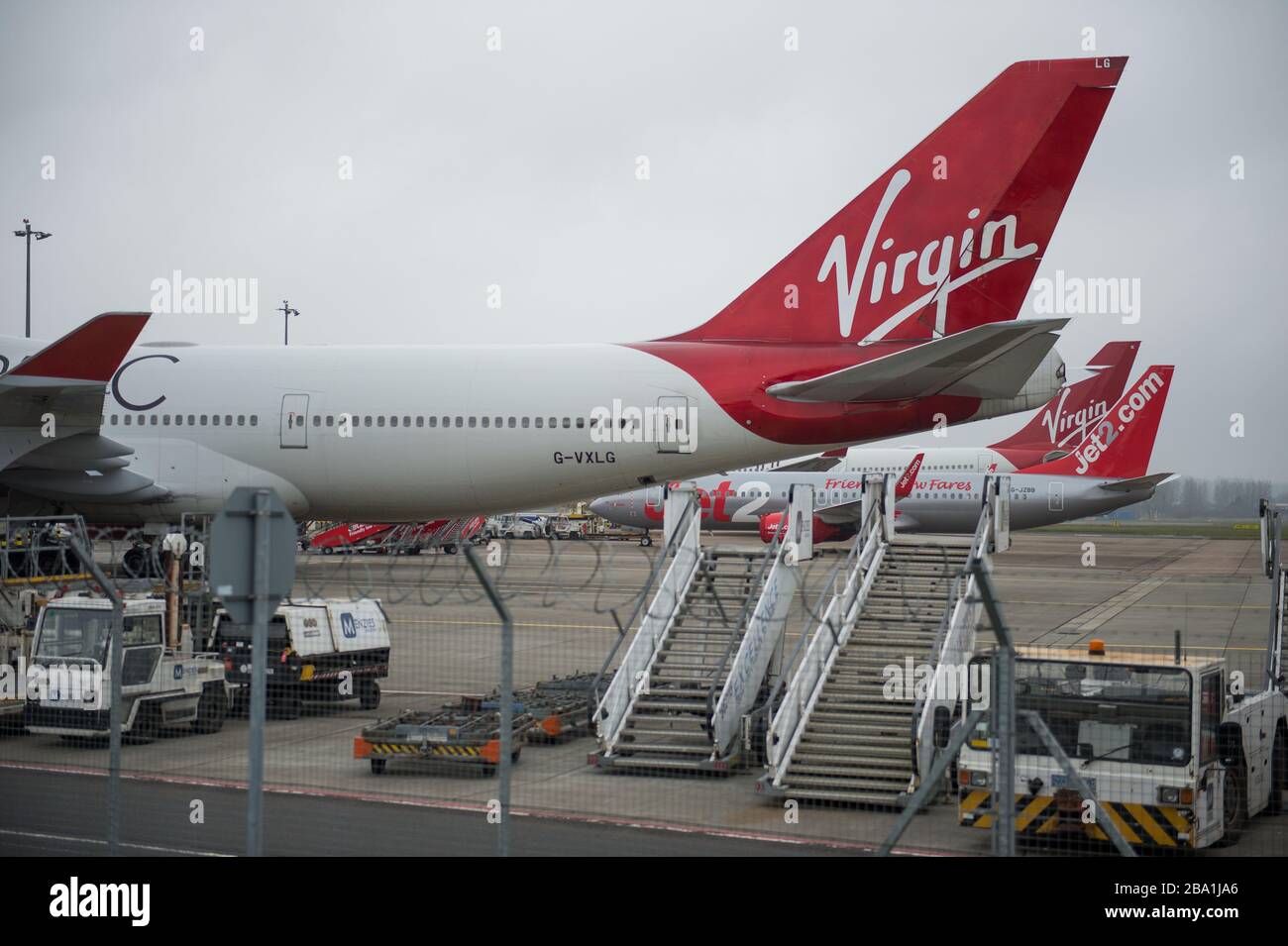 Glasgow, Royaume-Uni. 25 mars 2020. Photo : les avions Virgin Atlantic (Boeing 747-400 - nommé Ruby Tuesday, enregistré G-VXLG) et un Airbus A330-200 - nommé Honkytonk Woman, enregistré G-Vmik) sont mis à la terre sur le tarmac par le cintre Logan Air. Crédit : Colin Fisher/Alay Live News Banque D'Images