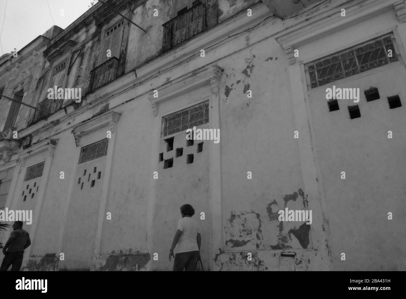 Les bidonvilles ont endommagé le bâtiment et les rues en décomposition à la Havane Cuba mur art peinture noir et blanc râper vieux style à l'extérieur de la rue personnes personne sale rail Banque D'Images