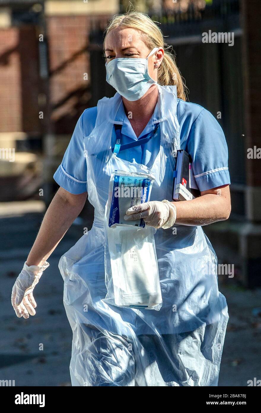 Une infirmière du NHS recueille plus de pansements de sa voiture comme elle fait une visite à domicile à Sefton Park, Liverpool après que le Premier ministre Boris Johnson a mis le Royaume-Uni en position de verrouillage pour aider à freiner la propagation du coronavirus. Photo PA. Date de l'image: Jeudi 26 mars 2020. Le nombre de morts de coronavirus au Royaume-Uni a atteint 463 mercredi. Voir l'histoire de PA SANTÉ Coronavirus. Crédit photo devrait lire: Peter Byrne/PA Wire Banque D'Images