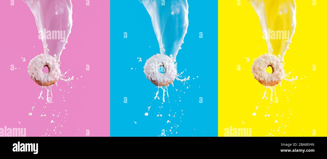 Anneau volant avec glaçage au chocolat blanc et éclaboussures de lait isolées sur fond rose, bleu et jaune. Concept de la cuisine douce. Publicité Fast food Banque D'Images