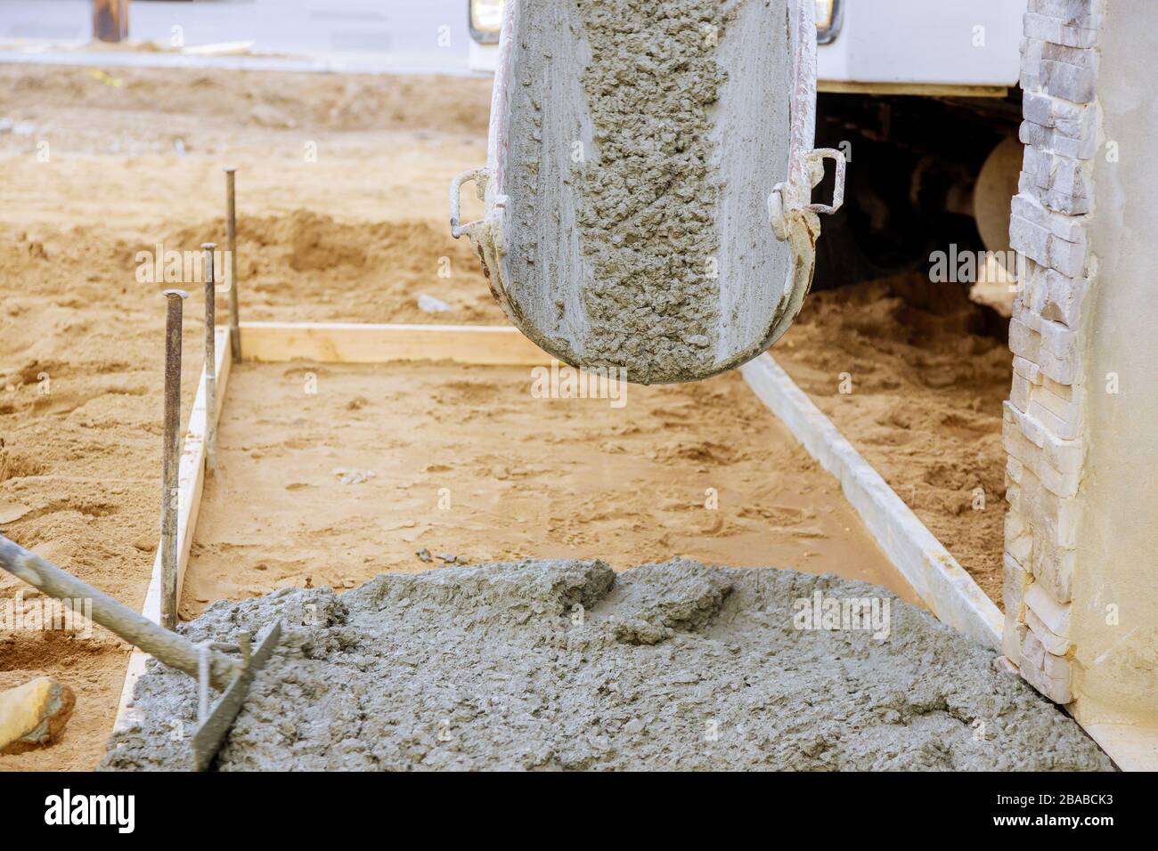 Construction d'un trottoir de béton autour d'une maison rurale