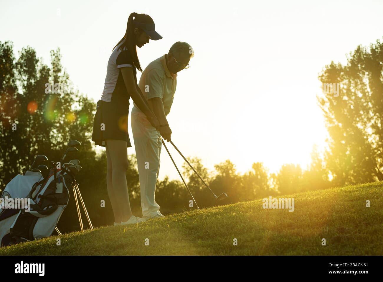 Jeunes femmes et personnes âgées pour jouer au golf Banque D'Images