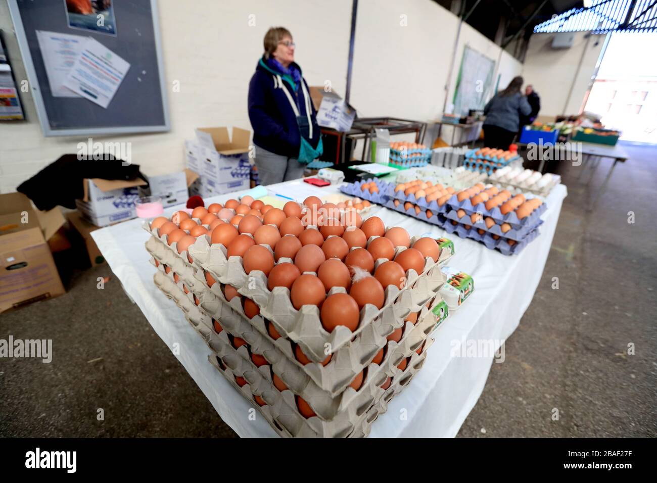 Propriétaire d'un marché avec des œufs en vente sur un marché agricole principalement vide à Melton Mowbray, Leicestershire comme le Royaume-Uni continue de se verrouiller pour aider à freiner la propagation du coronavirus. Banque D'Images
