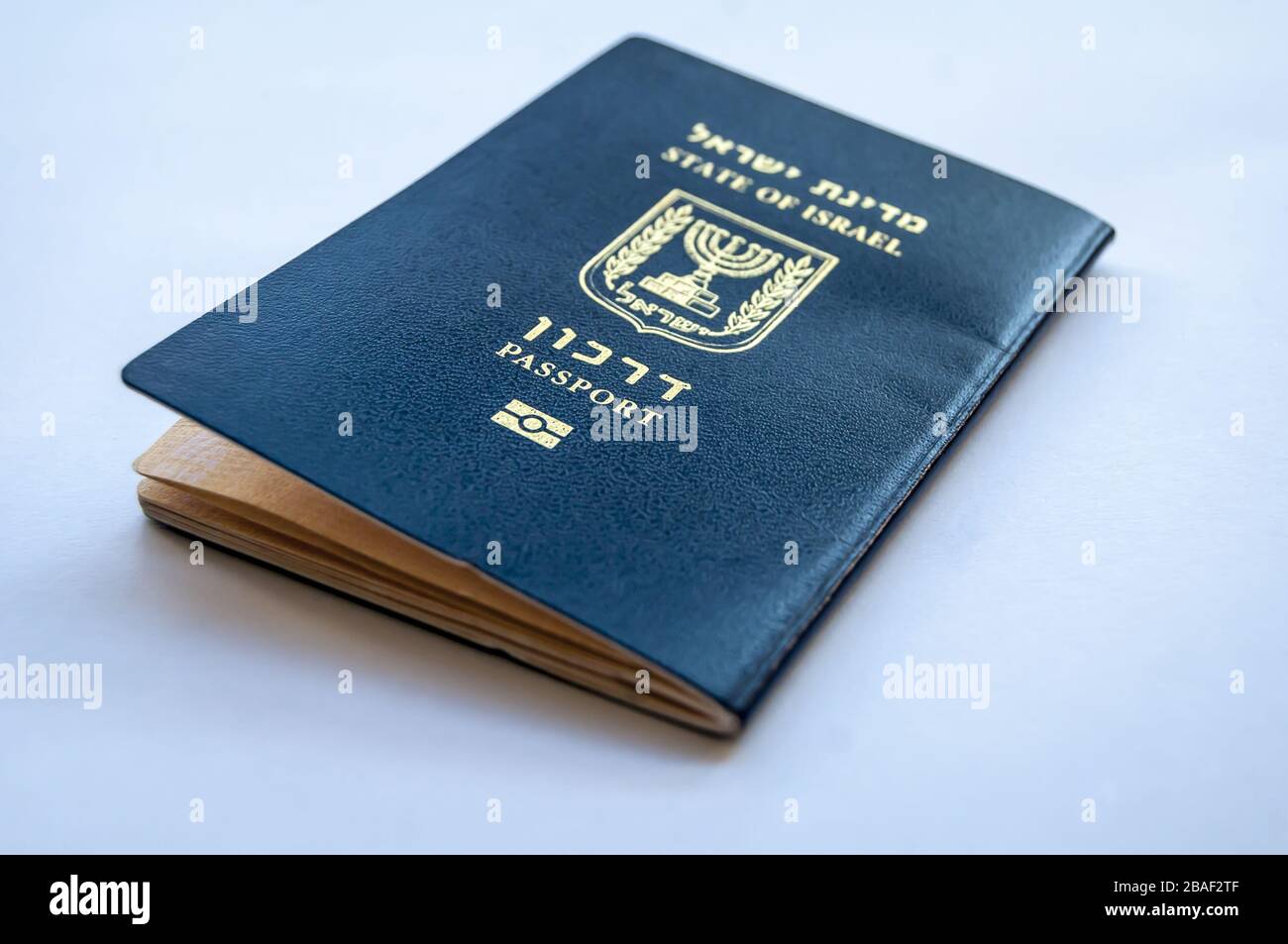 Passeport bleu de l'État d'Israël sur fond bleu clair. Concept de citoyenneté israélienne, image d'illustration du passeport « arkon » bio-métrique israélien Banque D'Images