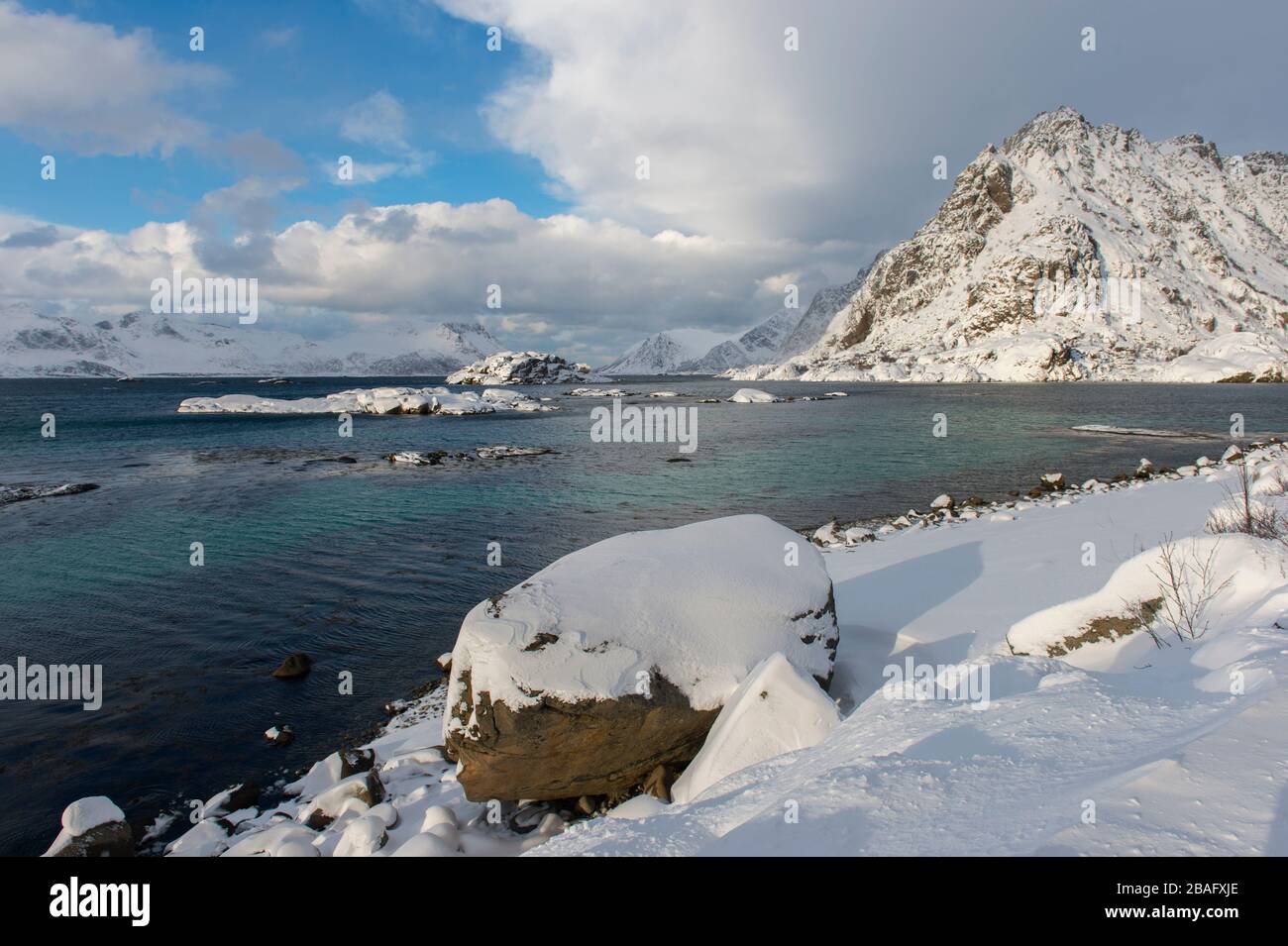Scène d'hiver avec vue sur la mer de Norvège et les montagnes enneigées près de Henningsvaer, un petit village de pêcheurs près de Svolvaer, dans les Lofoten est Banque D'Images