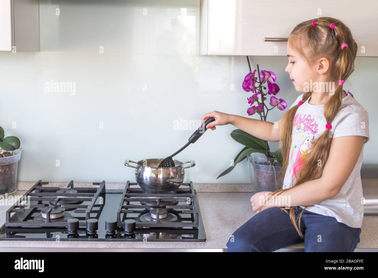 Des boulettes de cuisine pour petite fille sur la cuisine. Concept de quarantaine du coronavirus. Restez à la maison. Banque D'Images