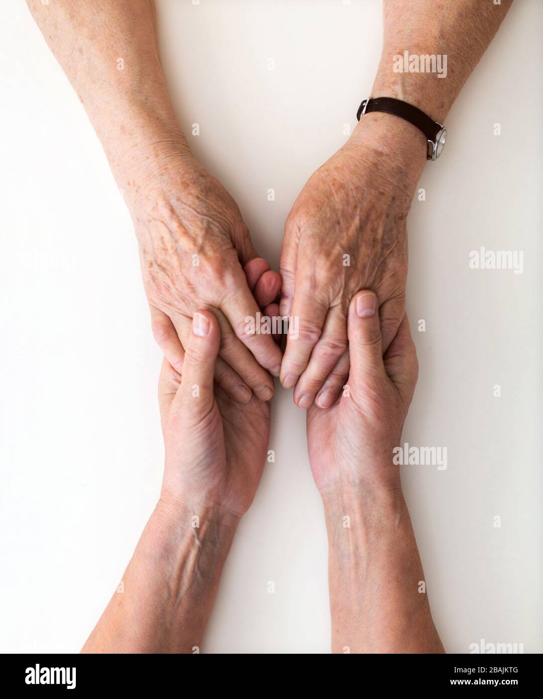 Infirmière consolant sa patiente âgée en la tenant les mains Banque D'Images