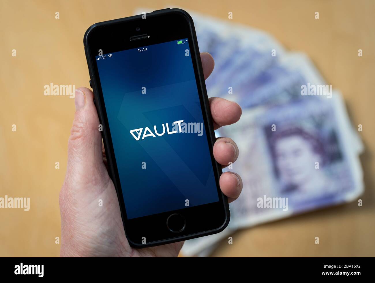 Une femme utilisant l'application DeVere Vault sur un téléphone mobile. (Usage éditorial uniquement) Banque D'Images