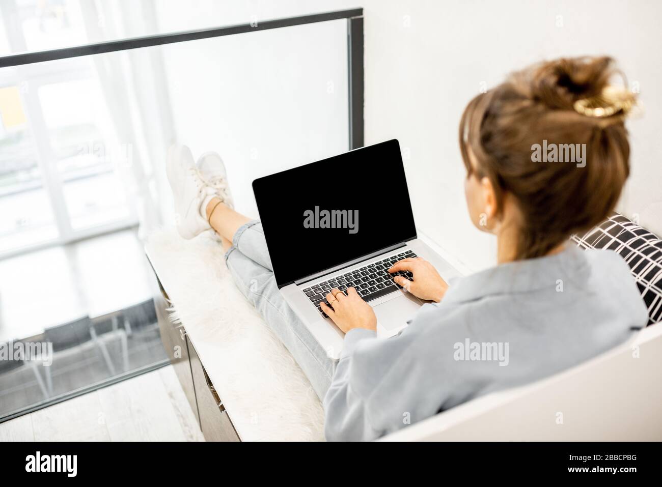 Femme travaillant sur ordinateur à la maison, ordinateur portable avec  écran noir pour copier coller. Concept d'un travail de la maison à  l'atmosphère confortable Photo Stock - Alamy