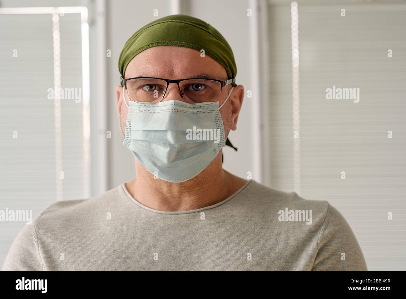 Gros plan portrait d'un médecin épuisé ou d'une infirmière autorisée portant un uniforme médical et un masque dans un hôpital. Coronavirus covid-19 et la collaboration en soins de santé Banque D'Images