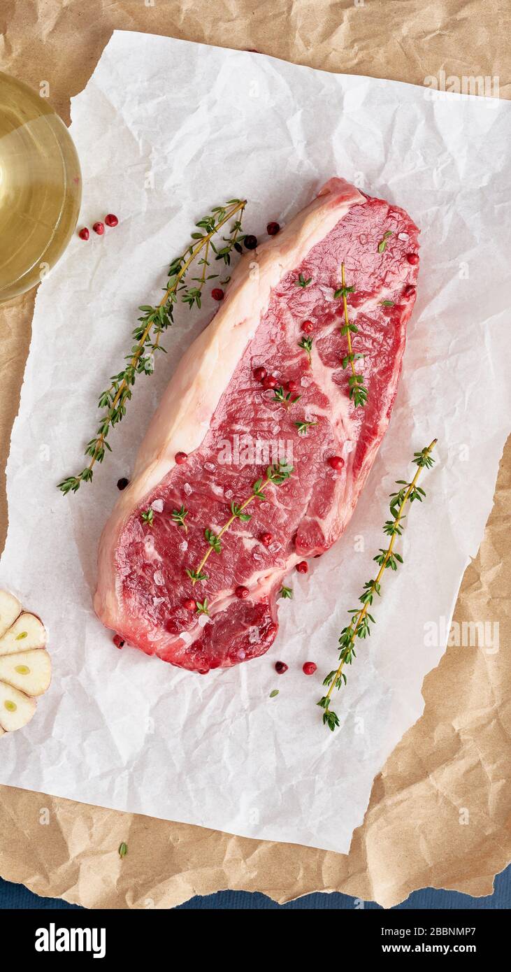 Gros morceau entier de viande de boeuf brute, stripline sur papier parchemin blanc Banque D'Images