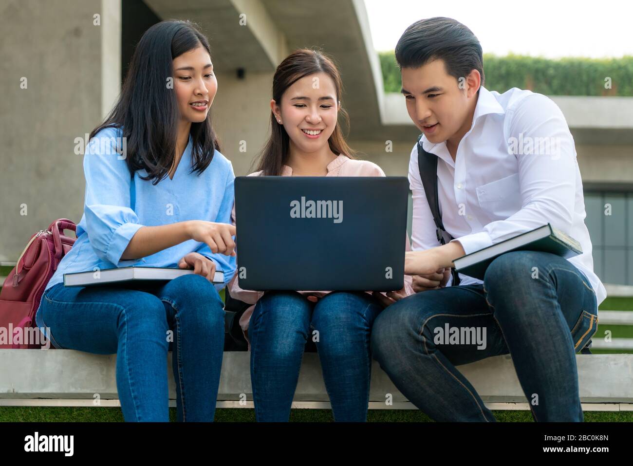 Trois étudiants asiatiques discutent de la préparation des examens, de la présentation, de l'étude, de l'étude pour la préparation des tests avec un ordinateur portable à l'Université. Éducation, Lear Banque D'Images