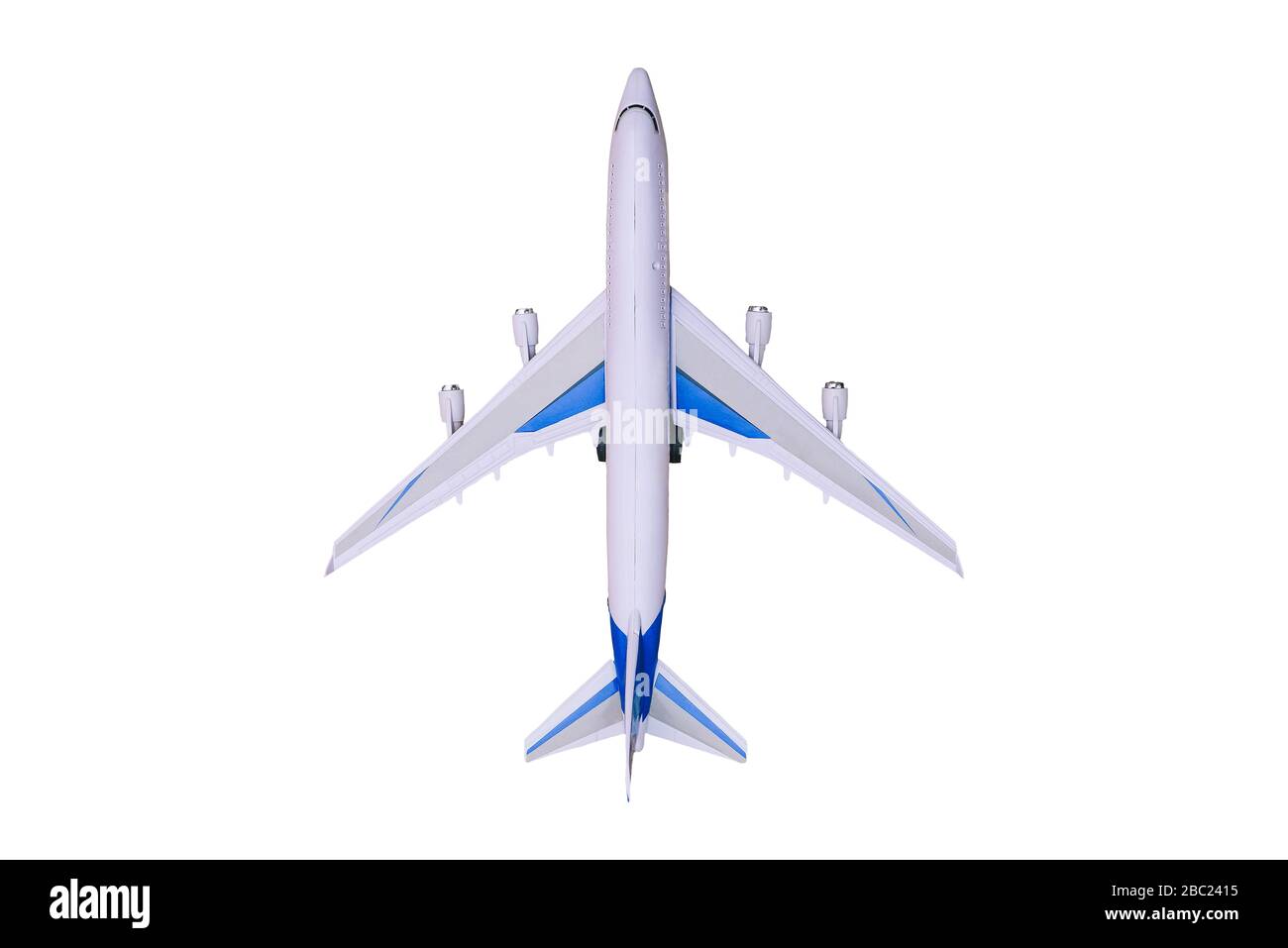 Modèle d'avion sur un fond blanc. Avion jouet, vue de dessus. Doublure passager pour le vol dans le monde entier. Voyages et tourisme Banque D'Images