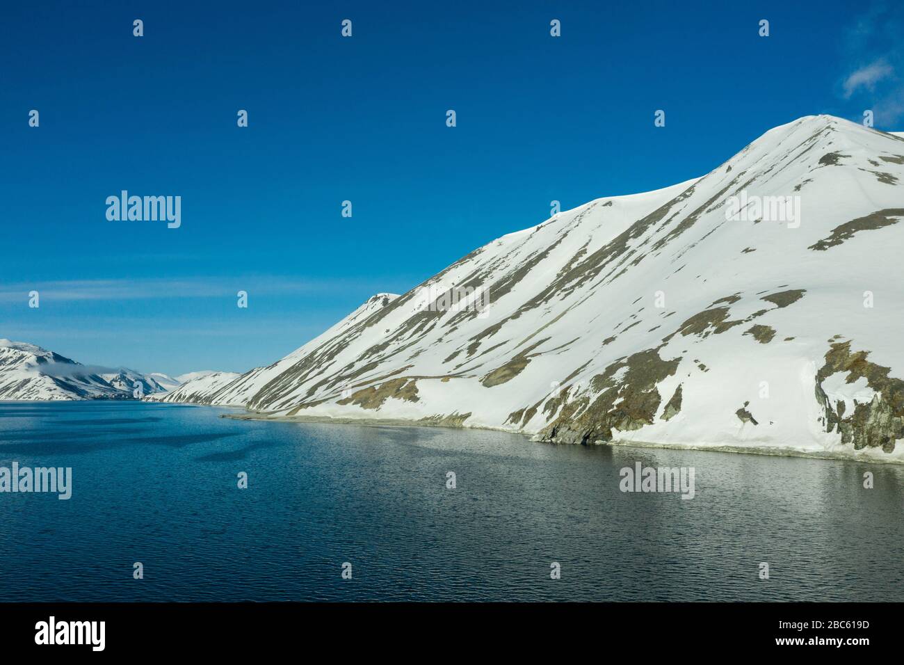 La côte montagneuse de la mer couverte de neige par un temps ensoleillé. Lieu de tournage sur la côte nord de la mer de Béring, région de Chukchi, Russie. Banque D'Images