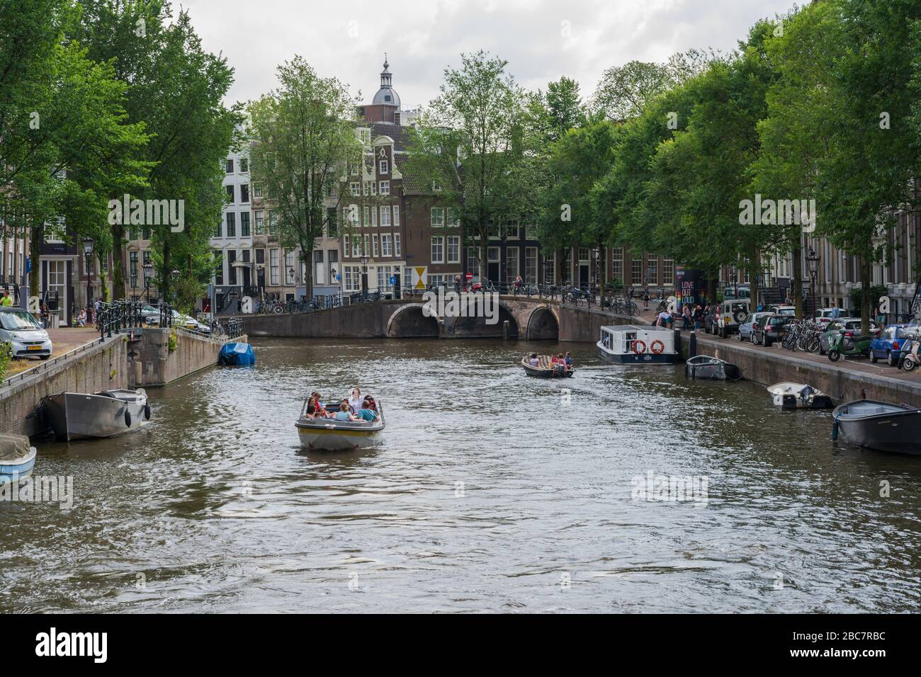 Amsterdam, Pays-Bas -- 29 juillet 2019. Les gens en petits bateaux prennent le temps de faire une croisière sur les nombreux beaux canaux d'Amsterdam un après-midi d'été. Banque D'Images