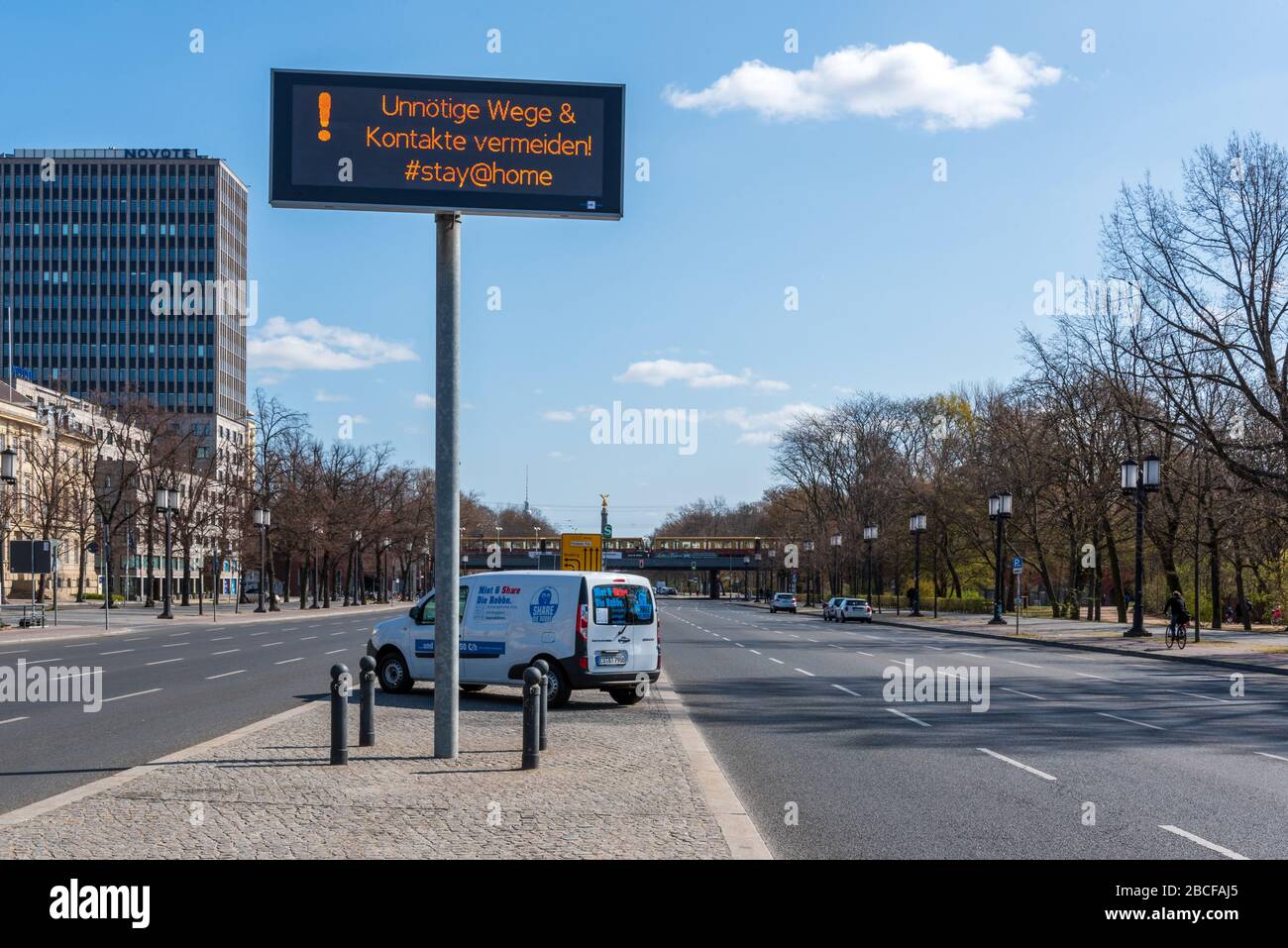 Panneau indiquant aux gens de rester à la maison et d'éviter tout contact inutile sur la Strasse des 17. Juni dans le centre de Berlin pendant le confinement COVID, avril 2020 Banque D'Images