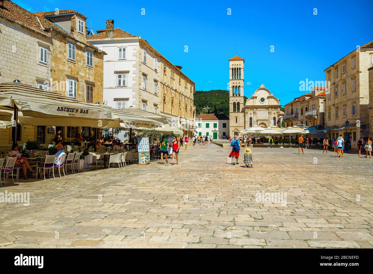HVAR, CROATIE - 24 JUIN 2019 : place de la vieille ville méditerranéenne avec restaurants et cafés de rue. Touristes sur la passerelle pavée de la ville de Hvar, Dalmatie, Banque D'Images