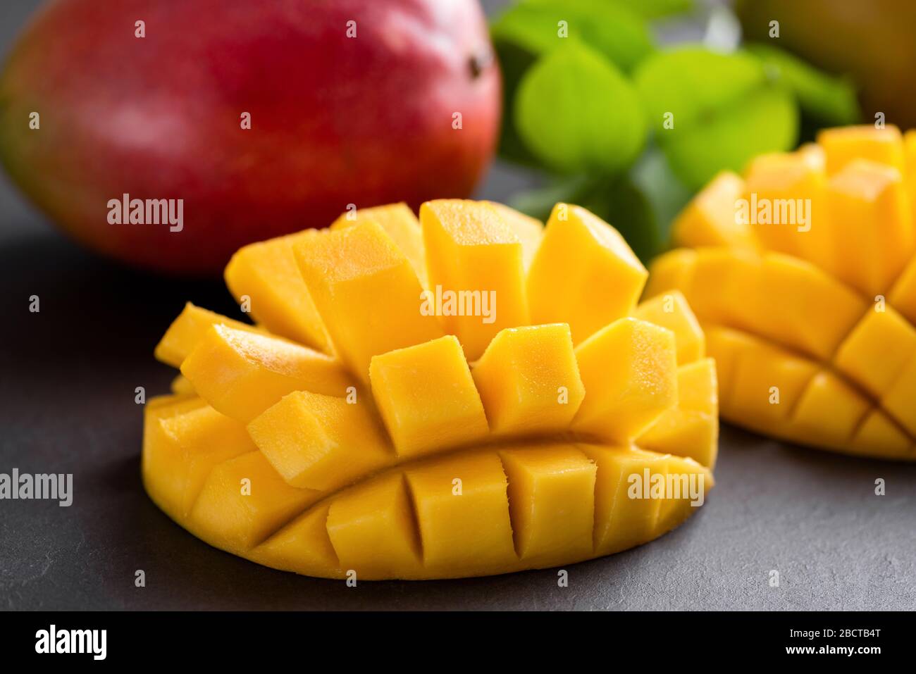 Coupe de mangue Juteux fruits tropicaux sur table en béton vue rapprochée. Belle cuvette de mangue Banque D'Images
