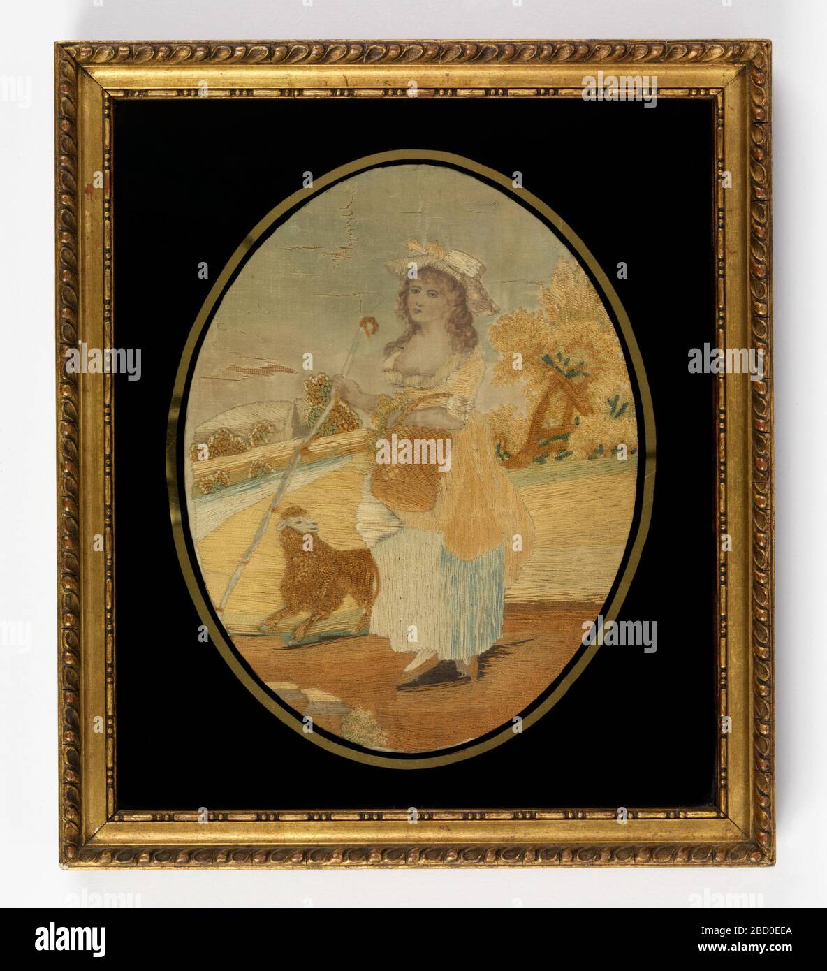 Photo brodée. Recherche en ProgressOval photo de la berphérisation transportant le crook et le panier dans un paysage rural avec un mouton à ses pieds. Cadre rectangulaire doré avec photo brodée en verre de lunettes noires Banque D'Images