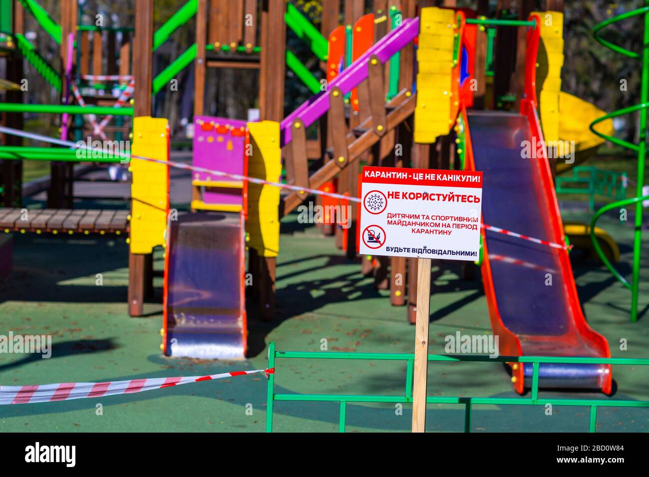 Aire de jeux pour enfants fermée et enveloppée dans un ruban de mise en garde pour la quarantaine mondiale du coronavirus.pas d'enfants sur les aires de jeux. Prévention du coronavirus Banque D'Images