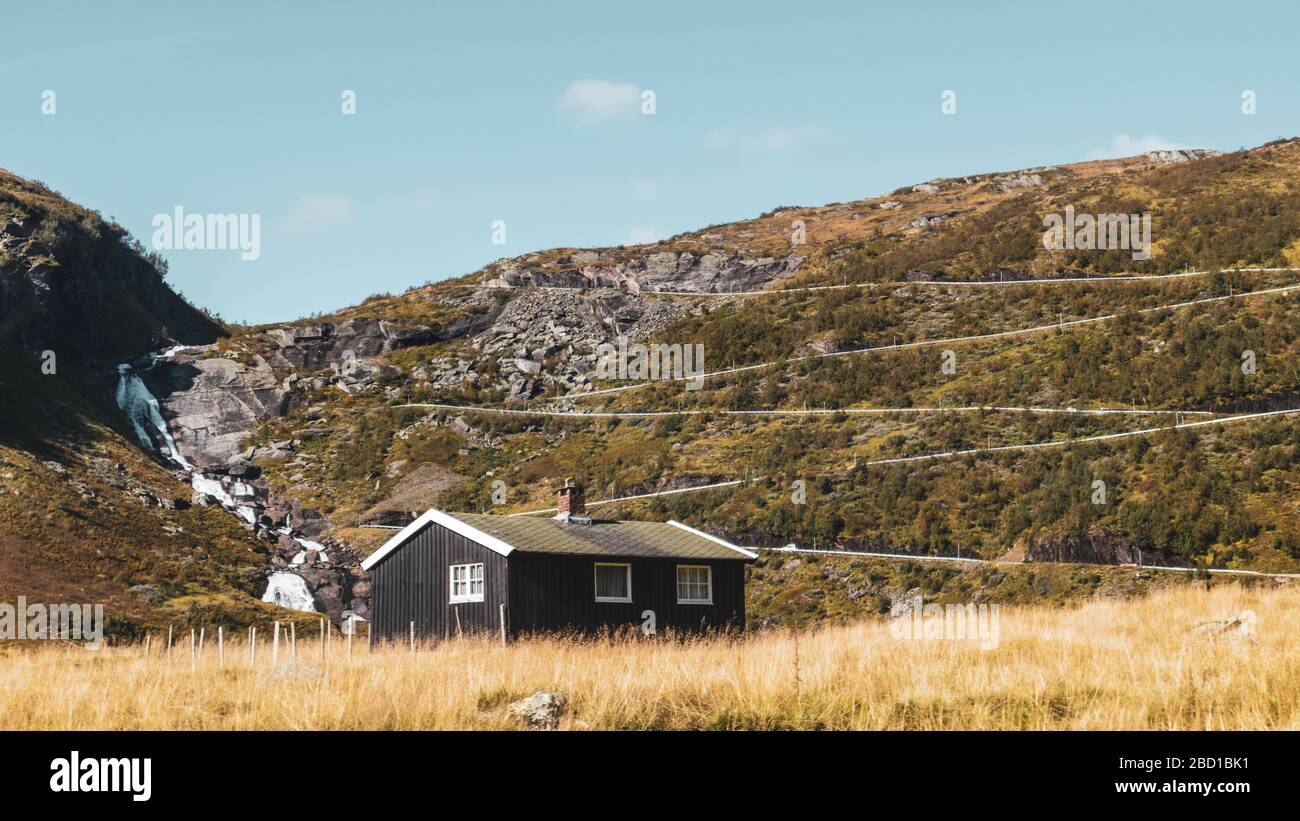 Maison noire traditionnelle norvégienne sur la route de montagne de serpentine sur la colline vue en couleur dégradée. En automne, la scandinavie Myrkdalsvegen Serpentinveg, Banque D'Images