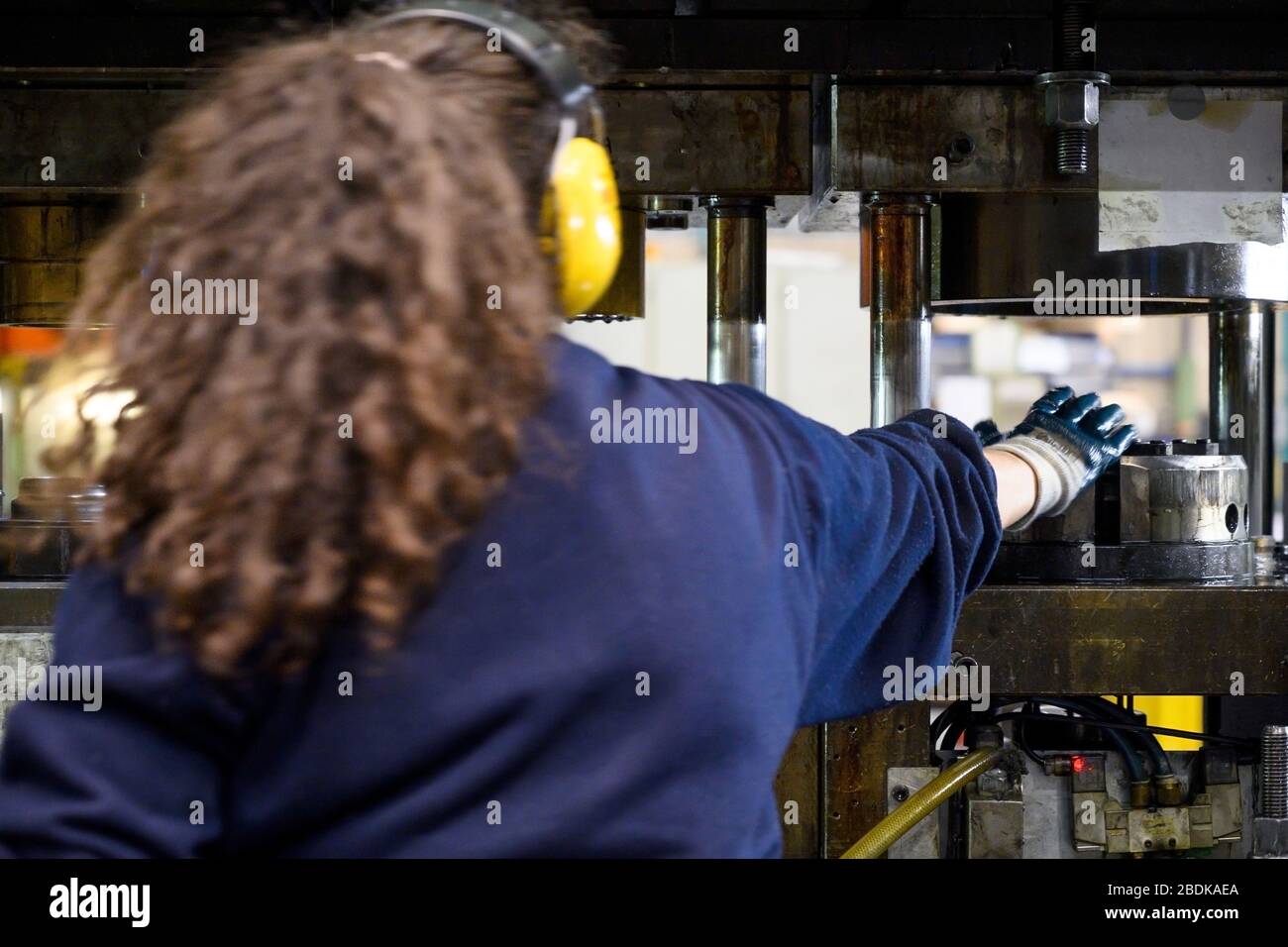Femme non reconnaissable travaillant dans une usine . Banque D'Images
