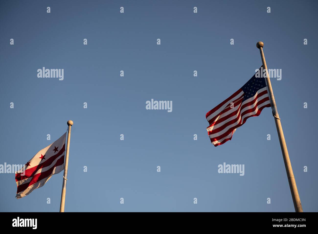 Washington, États-Unis. 08 avril 2020. Le drapeau américain et le drapeau du District de Columbia volent côte à côte à Washington, DC, le mercredi 8 avril 2020, comme on l'a vu au milieu de l'épidémie mondiale de coronavirus. Comme les cas confirmés ont atteint 1,5 million dans le monde entier, avec plus de 400 000 aux États-Unis seulement, les rapports de presse ont révélé une réponse à la traîne de l'administration Trump dans les premiers jours de l'épidémie. (Graeme Sloan/Sipa USA) crédit: SIPA USA/Alay Live News Banque D'Images