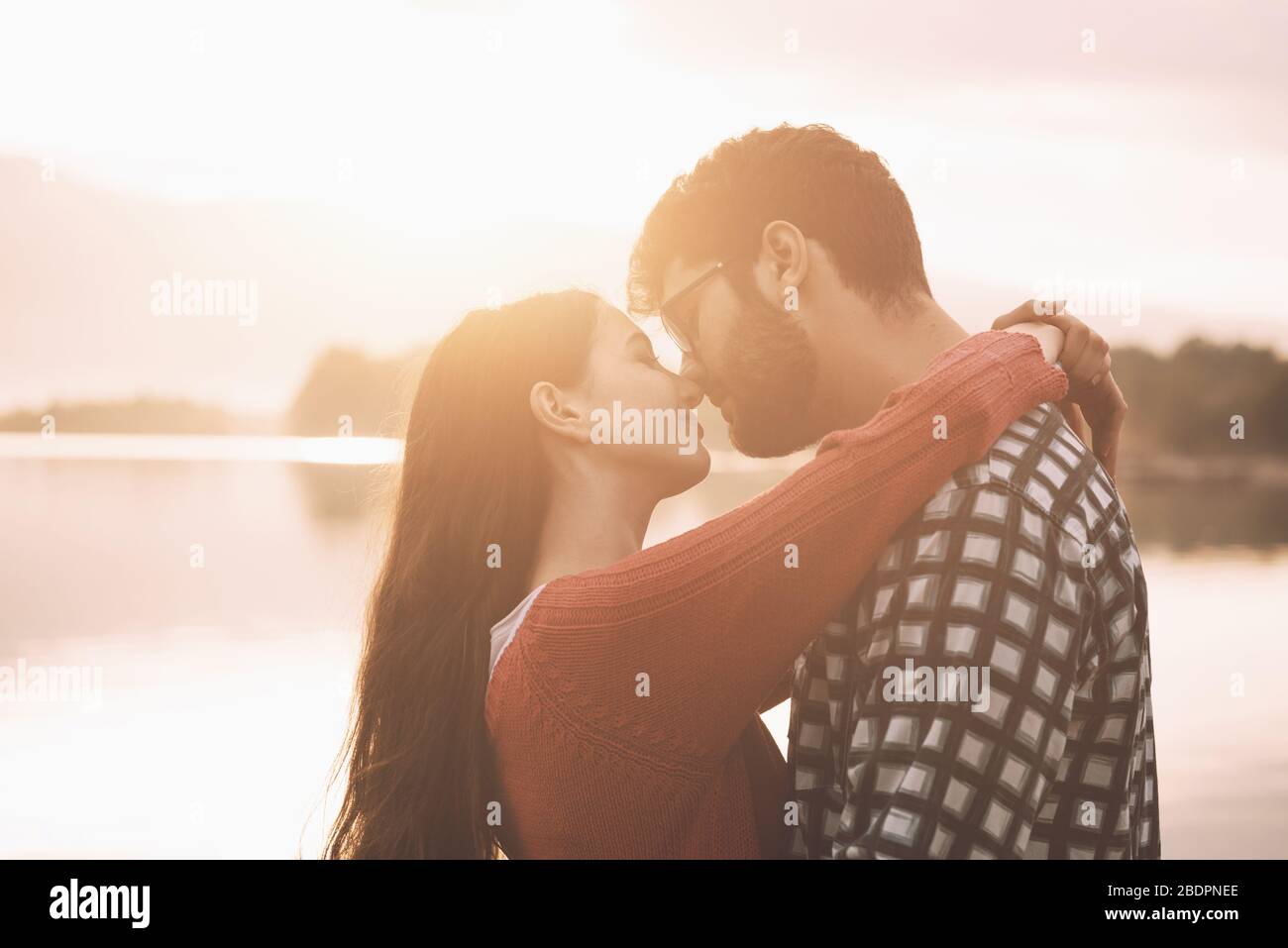 Jeune couple romantique embrassant dehors au lac, la jeunesse et les relations concept Banque D'Images