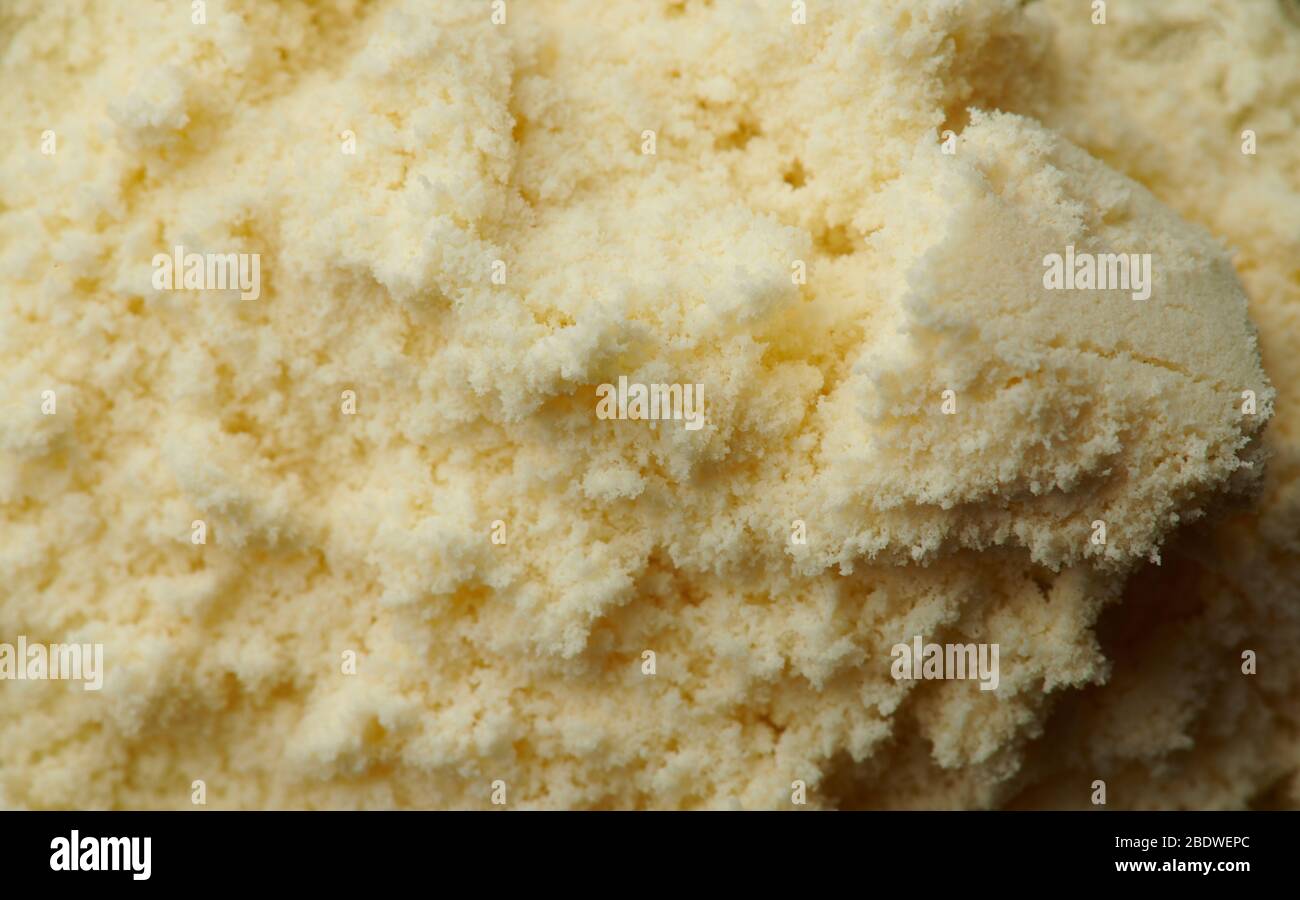 Macro de fond de gros plan de poudre de lait jaune sec Banque D'Images
