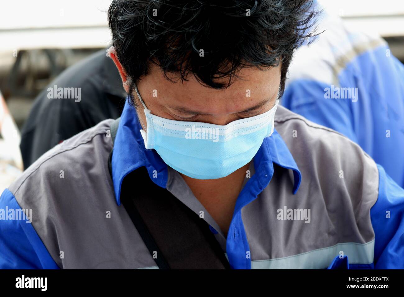 Utiliser un masque facial au travail pour prévenir les maladies transmissibles. Banque D'Images