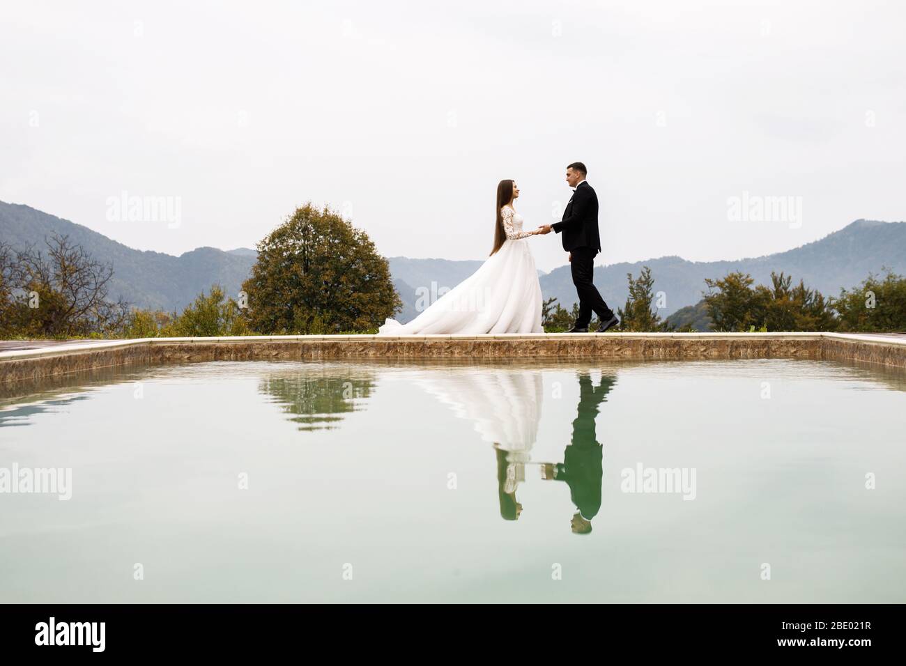 Anniversaire de mariage jeunes gens sympathiques. Jeune couple amoureux. Une histoire d'amour près de la piscine. Banque D'Images