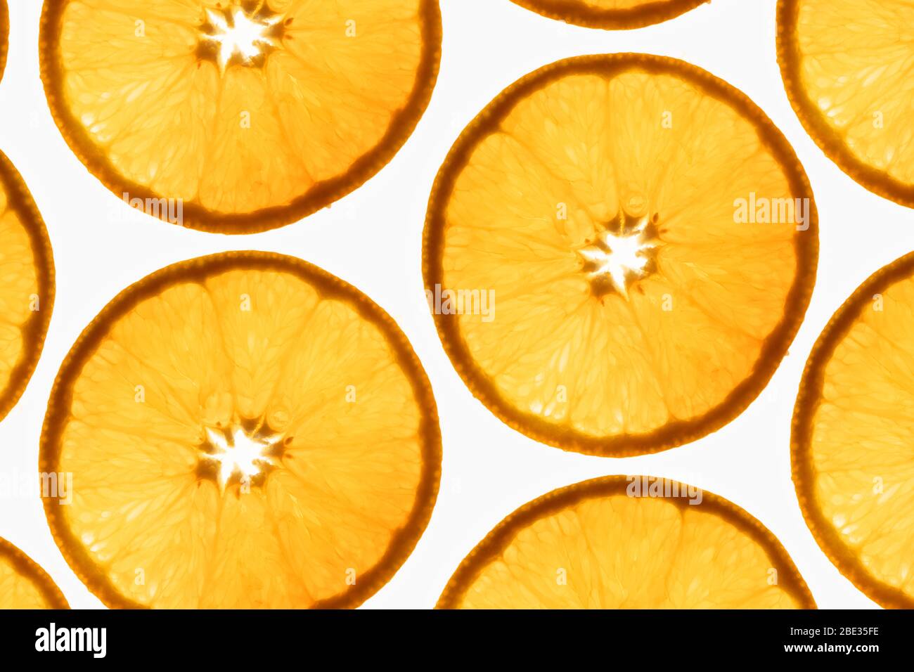 un motif intéressant de coupes orange transparentes sur un fond blanc brillant Banque D'Images