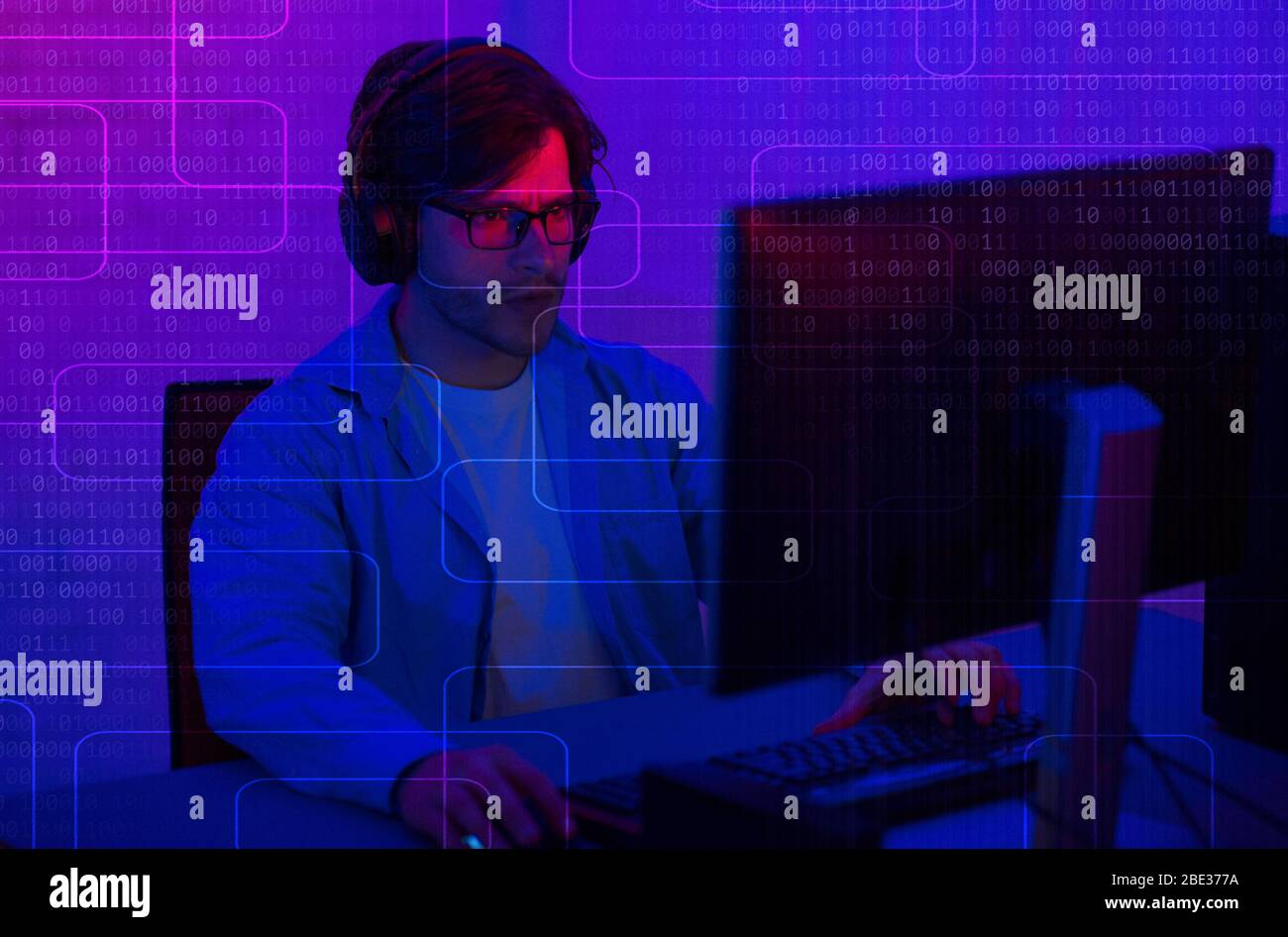 Programmation dans le casque de l'ordinateur. Double écran avec code binaire Banque D'Images