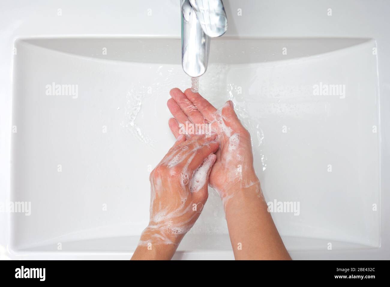 Lavage des mains. Une femme utilise du savon et se lave les mains sous le robinet. Concept d'hygiène. Vue rapprochée Banque D'Images