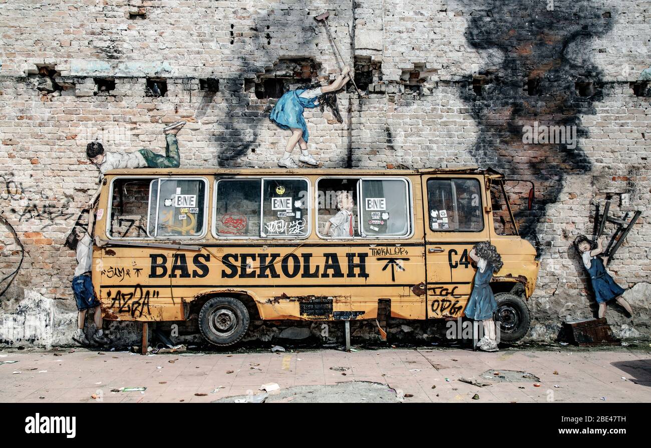 Art de rue malaisien dans le quartier chinois de Kuala Lumpur, les enfants détruisant le bus scolaire - Arte urbano de malasia, niños destrozan autobus del colegio Banque D'Images
