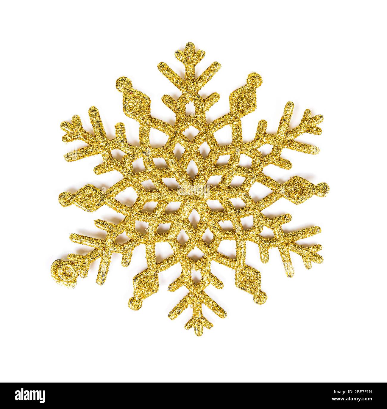 Texture pailletée dorée flocon de neige isolé sur fond blanc. Banque D'Images
