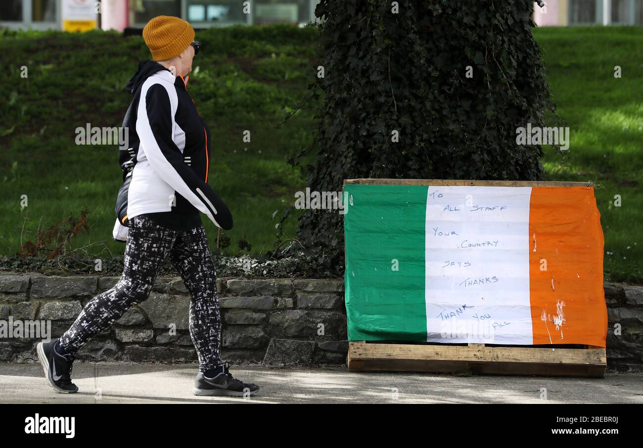 Une femme transmet un message de remerciement à une tricolore laissée en dehors de l'hôpital général de Naas car des restrictions restent en place en Irlande pour aider à freiner la propagation du coronavirus. Banque D'Images