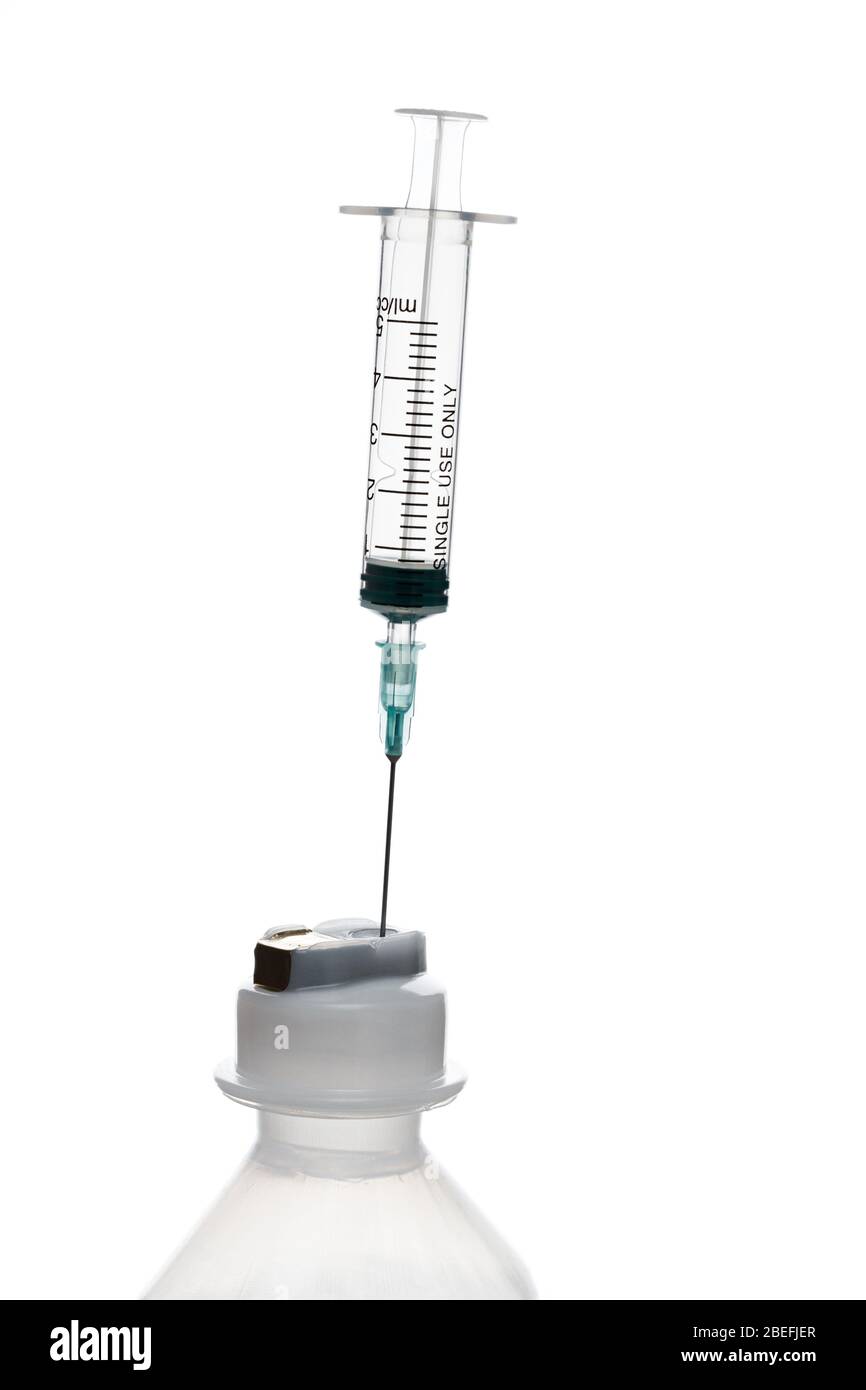 Seringue vide pour injection avec un cou d'une bouteille en plastique sur un fond blanc. Banque D'Images