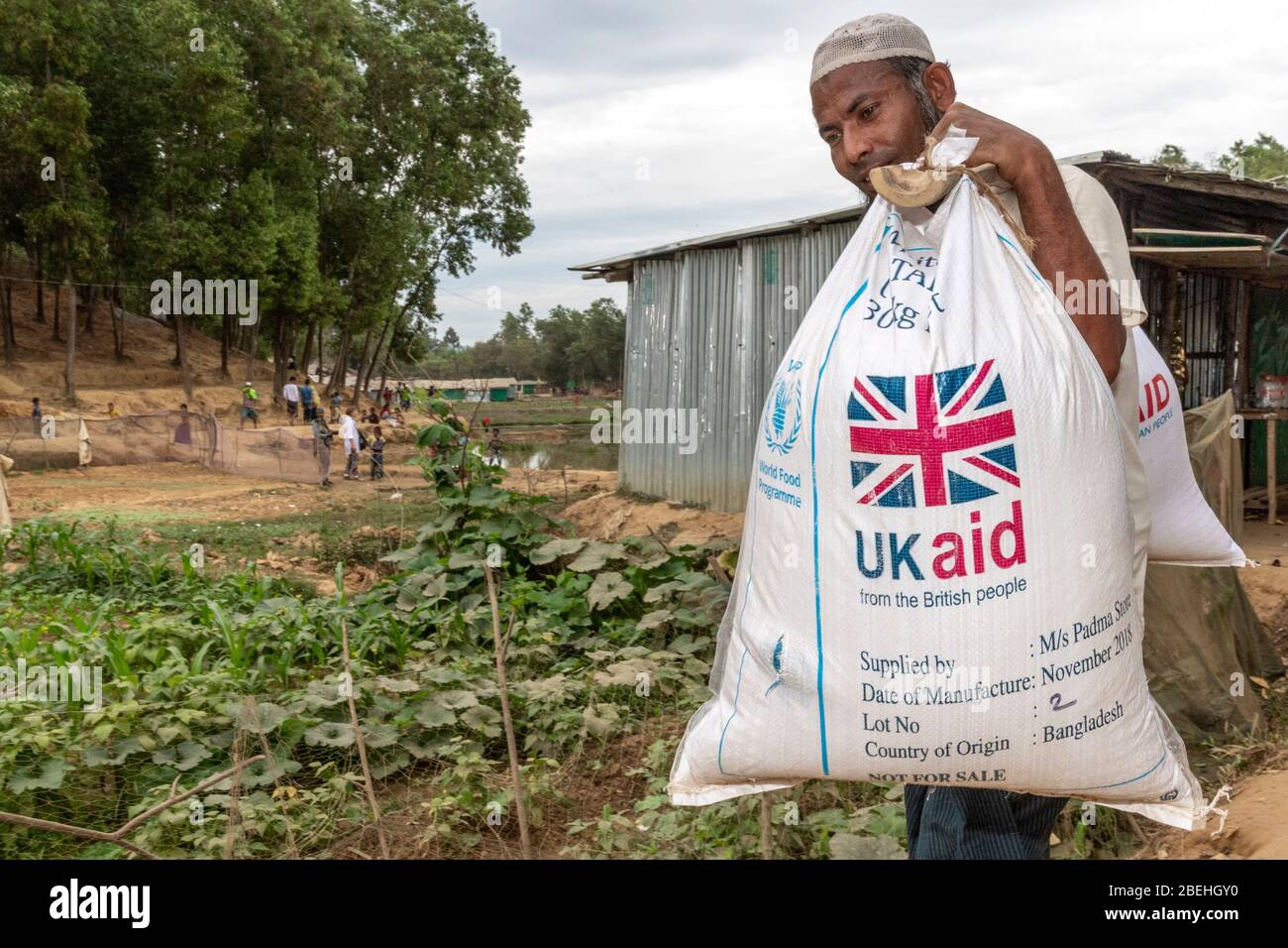 Rohingya homme âgé portant UN sac d'aide britannique dans un camp de réfugiés, au sud de Cox's Bazar près de la frontière avec le Myanmar. Banque D'Images