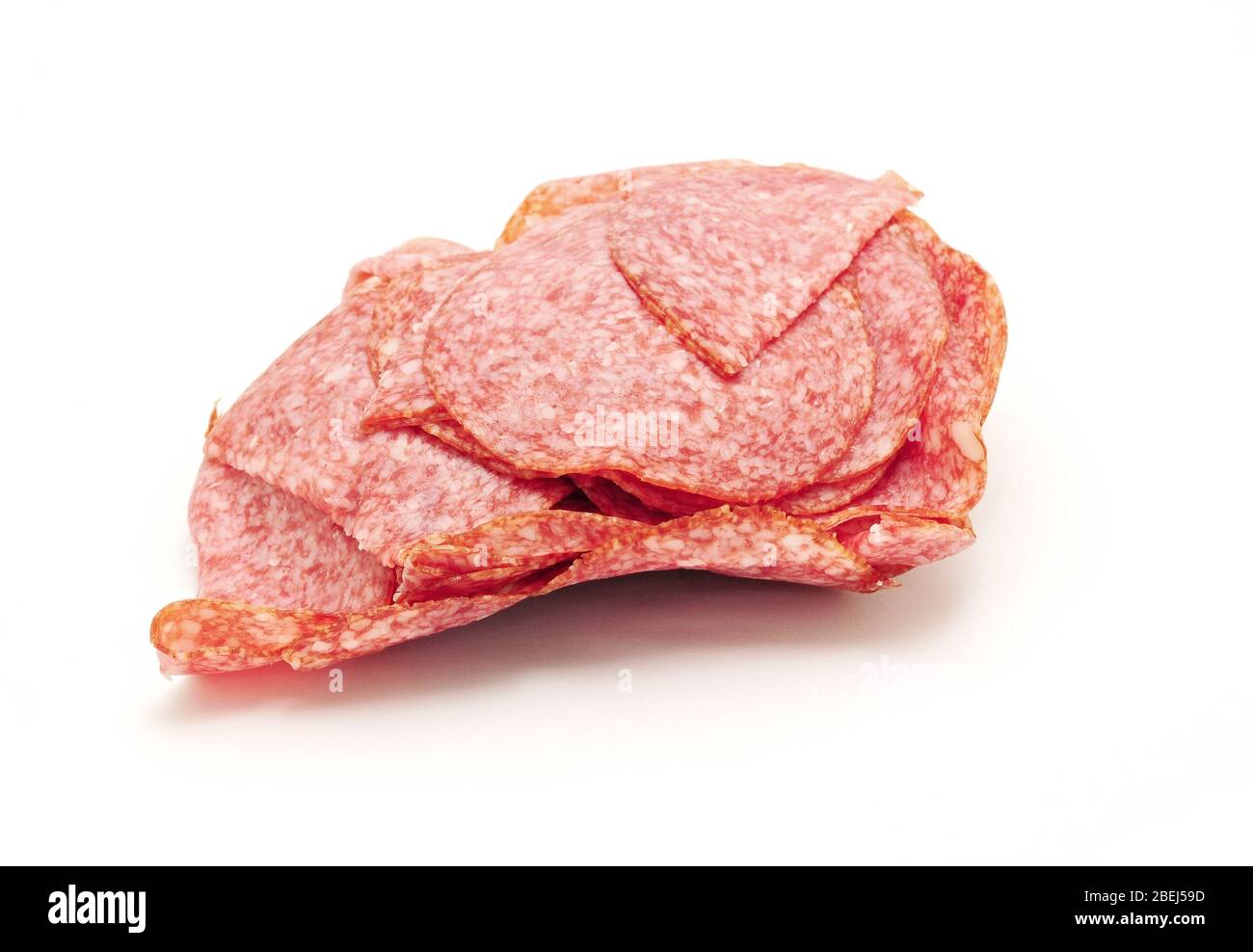 Tas de salami finement tranché sur fond blanc. Banque D'Images