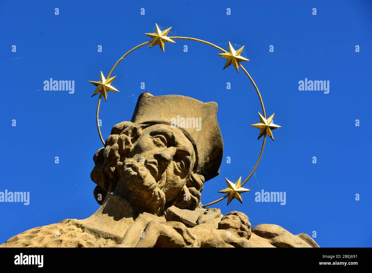 Détail de la statue de Saint Nepomuk en pierre baroque avec une couronne d'étoiles sur le pont en pierre, République tchèque, journée ensoleillée avec ciel bleu Banque D'Images