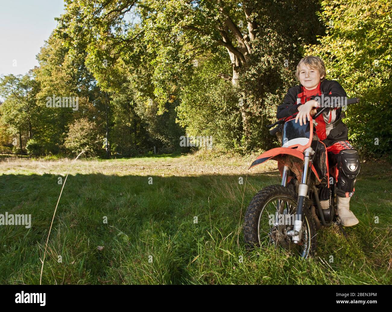garçon de 12 ans ayant une pause sur sa moto tout-terrain Banque D'Images