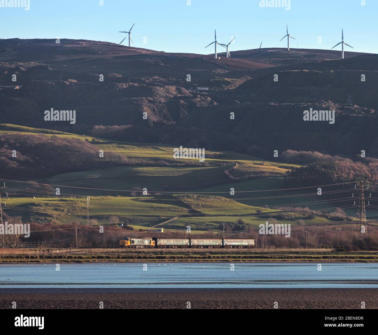 Locomotive DRS classe 37 passant par Foxfield par l'estuaire de Duddon sur la ligne de chemin de fer pittoresque de la côte Cumbrienne avec un service de voyageurs du rail du Nord Banque D'Images
