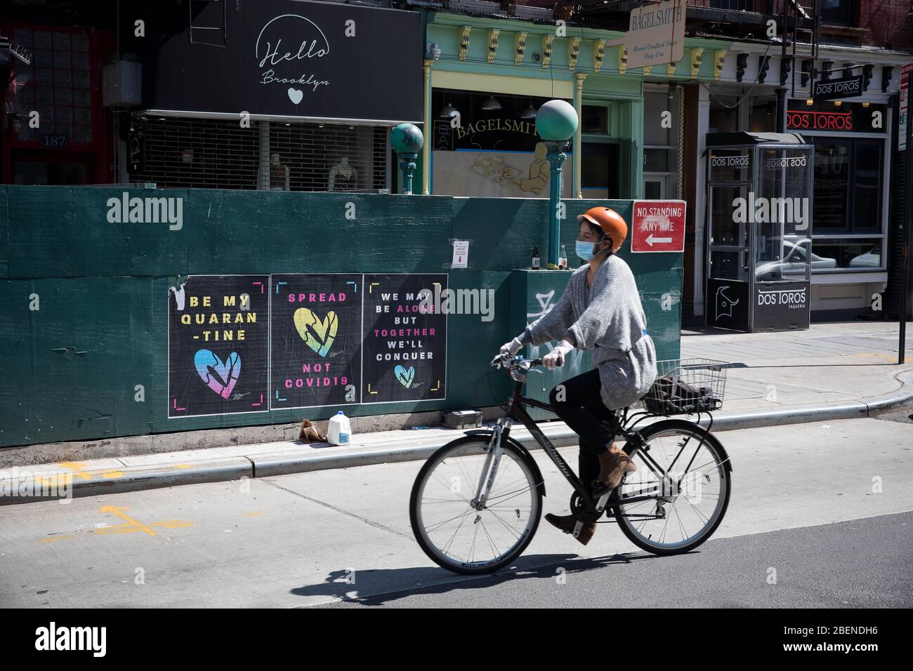 New York, États-Unis. 14 avril 2020. Une femme passe devant les affiches d'art de rue COVID-19 pendant la pandémie de coronavirus dans le quartier de Brooklyn à New York, aux États-Unis, le 14 avril 2020. Le nombre de cas de COVID-19 aux États-Unis a dépassé 600 000 mardi soir, selon le Centre de science et d'ingénierie des systèmes (CSSE) de l'Université Johns Hopkins. Selon le CSSE, le pays a connu 60 989 cas avec 25 575 morts à 18 h 50 (2 250 GMT). Crédit: Michael Nagle/Xinhua/Alay Live News Banque D'Images