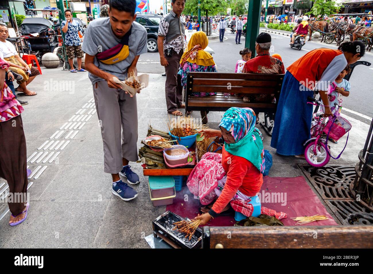 Une femme indonésienne vendant des collations dans la rue Malioboro, Yogyakarta, Indonésie. Banque D'Images